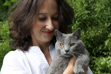 photograph of Muriel Barbery holding one of her gray, Chartreux cats. 
